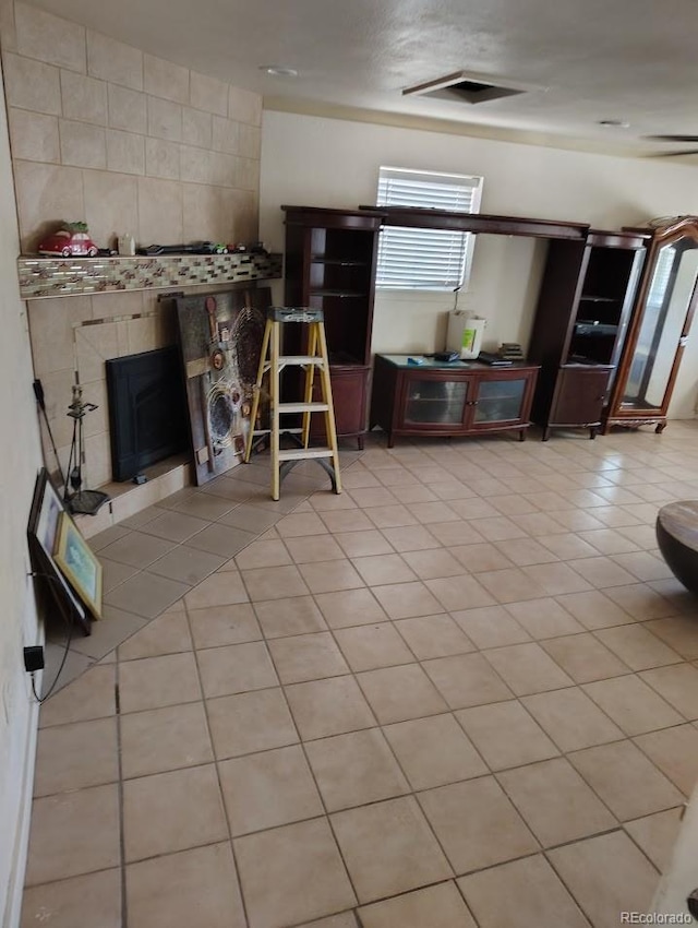 interior space featuring tile patterned floors, visible vents, and a tile fireplace