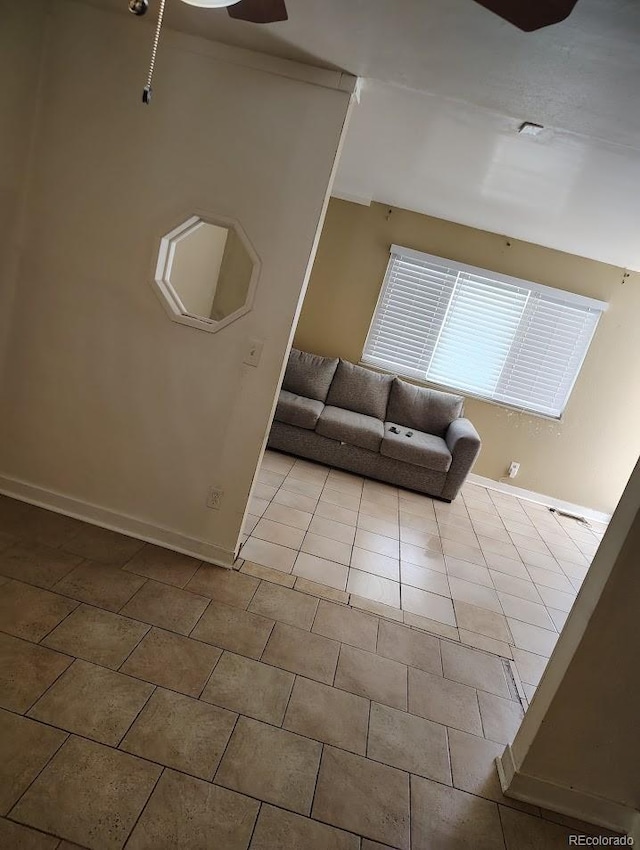 unfurnished living room featuring tile patterned floors and baseboards