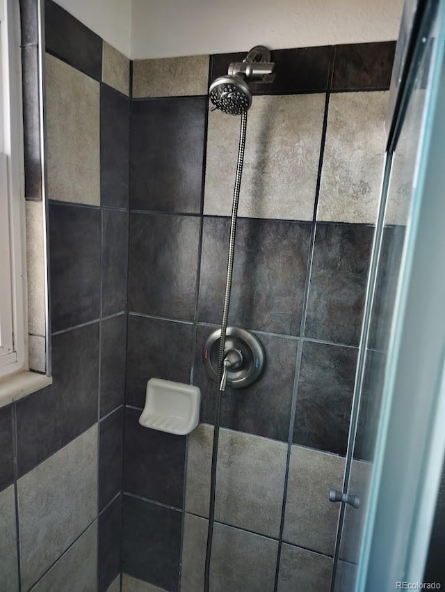 interior details featuring a stall shower