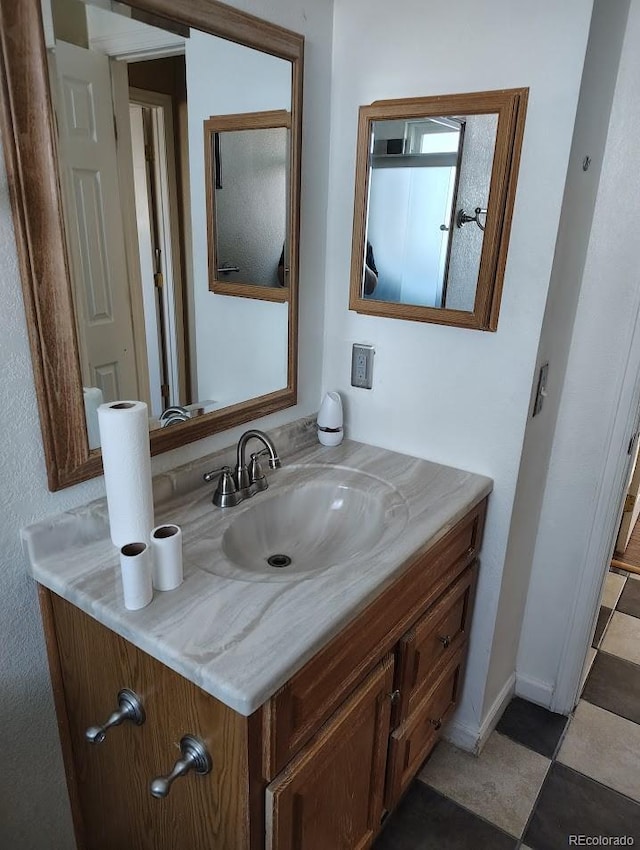 bathroom with vanity and baseboards