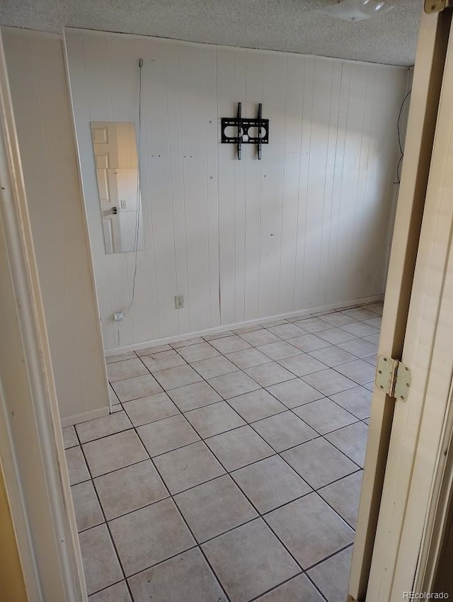 empty room featuring baseboards and a textured ceiling