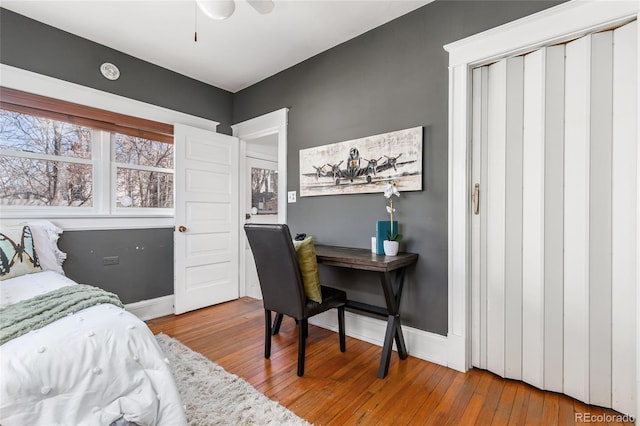 bedroom featuring baseboards and hardwood / wood-style flooring