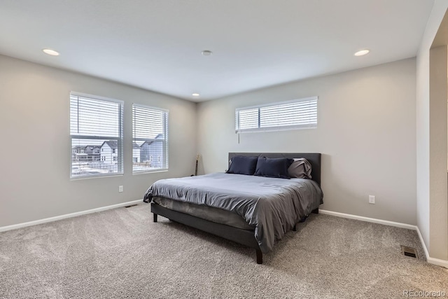 carpeted bedroom featuring visible vents, baseboards, and recessed lighting