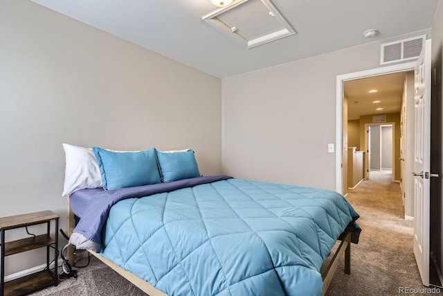 carpeted bedroom with visible vents and attic access