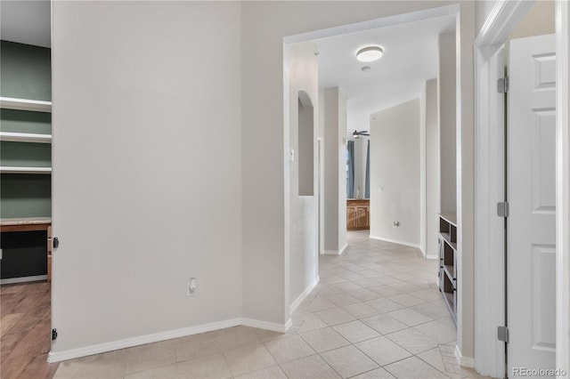 corridor featuring light tile patterned floors