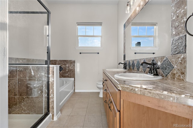 full bathroom with toilet, shower with separate bathtub, vanity, and tile patterned floors