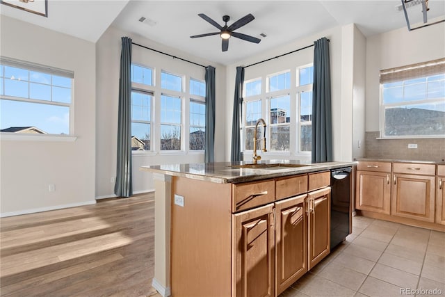 kitchen featuring a center island, light hardwood / wood-style floors, a wealth of natural light, and sink