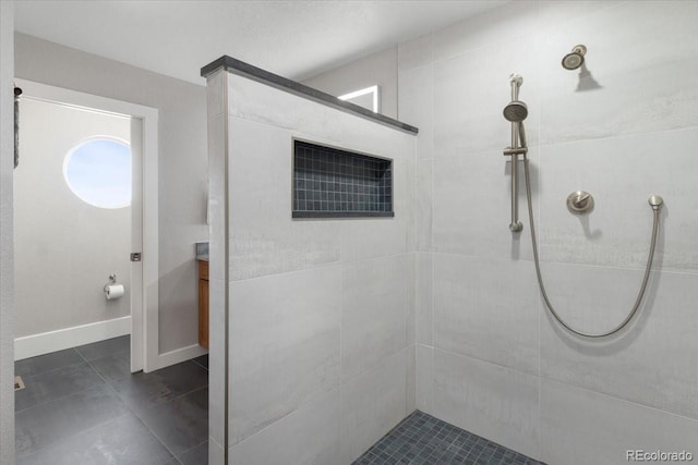 bathroom with a wealth of natural light and a tile shower