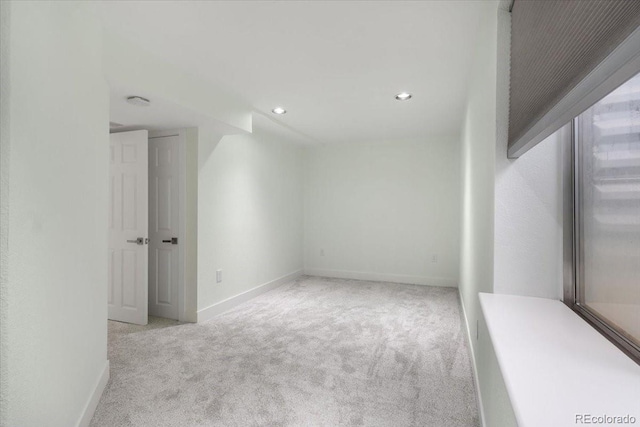 unfurnished room featuring light carpet