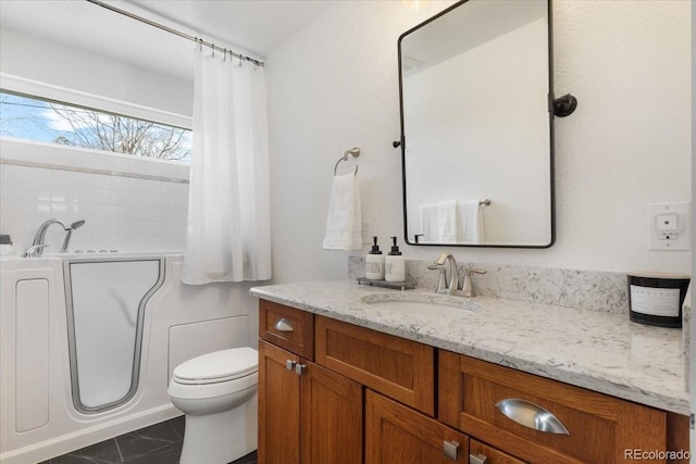 bathroom featuring toilet, vanity, a bath, and tile patterned flooring