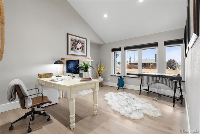 office featuring high vaulted ceiling and light hardwood / wood-style floors