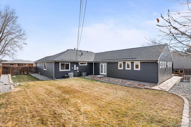 back of property featuring cooling unit and a lawn