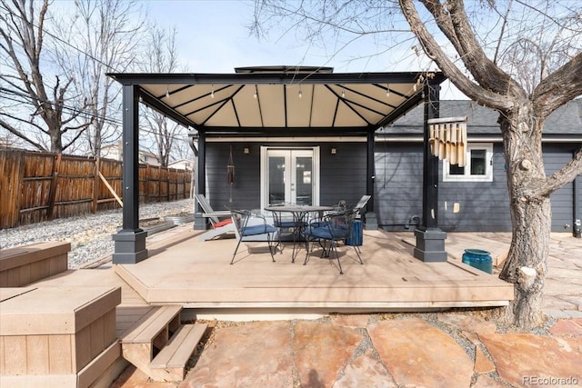 back of house with a wooden deck, a gazebo, and french doors