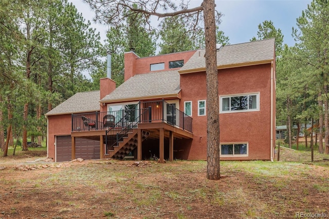 753 Edge Hill Dr, Woodland Park, CO 80863 - rear view of property with a shingled roof, a deck, stairs, a chimney, and stucco siding