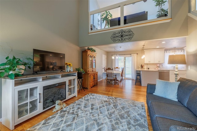 753 Edge Hill Dr, Woodland Park, CO 80863 - living area with a towering ceiling and light wood-style floors