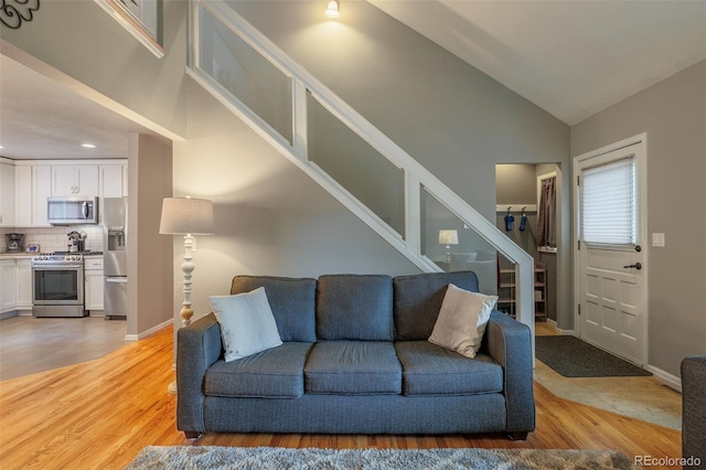 753 Edge Hill Dr, Woodland Park, CO 80863 - living room featuring stairway, light wood finished floors, lofted ceiling, and recessed lighting