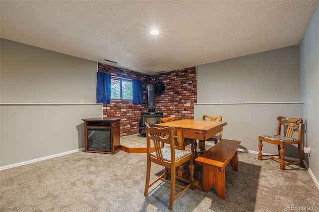 753 Edge Hill Dr, Woodland Park, CO 80863 - dining room with a textured ceiling, carpet flooring, a wood stove, and recessed lighting