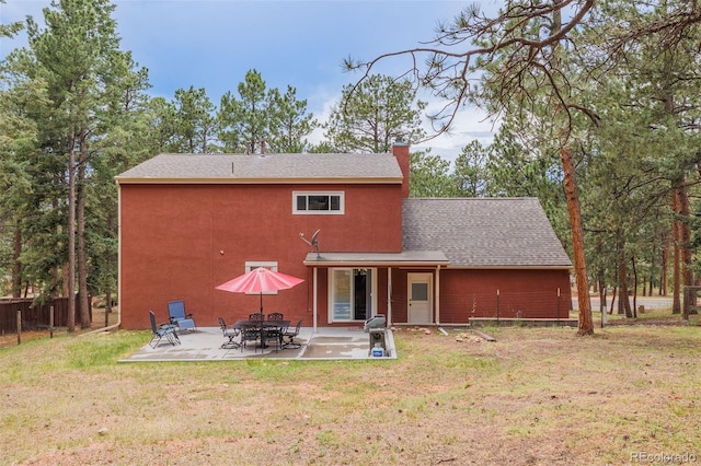 753 Edge Hill Dr, Woodland Park, CO 80863 - back of property featuring a shingled roof, a patio, and a chimney