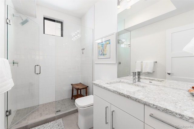 bathroom with a stall shower, vanity, toilet, and visible vents