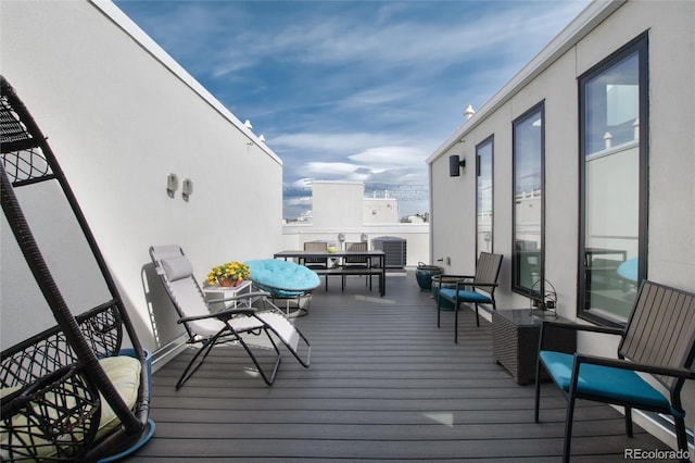 wooden deck with central AC and outdoor dining space