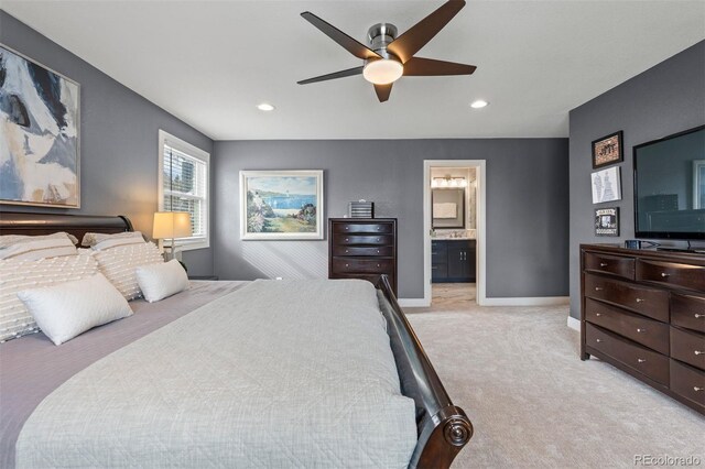 bedroom with light carpet, recessed lighting, ensuite bath, and baseboards