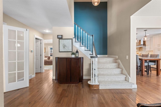 stairs with wood-type flooring and baseboards