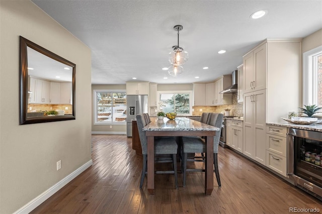 dining space featuring dark wood-style floors, recessed lighting, beverage cooler, and baseboards