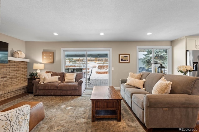 living area with a textured ceiling and recessed lighting