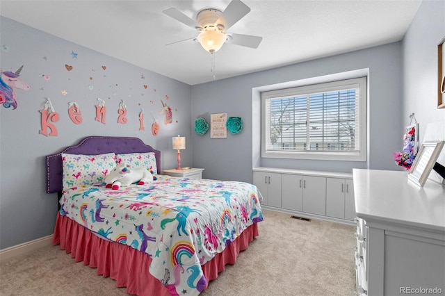 bedroom featuring baseboards, ceiling fan, visible vents, and light colored carpet