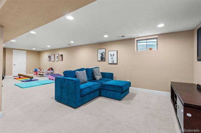 living area with light carpet, recessed lighting, visible vents, and baseboards