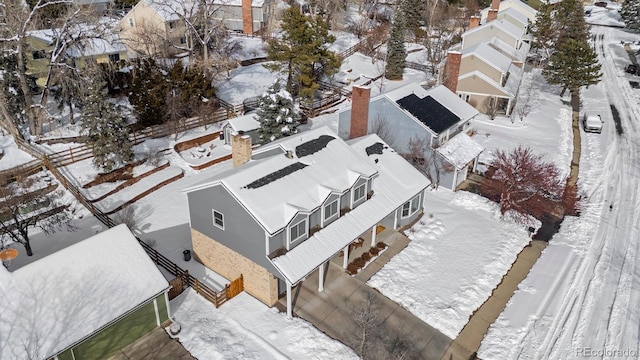 snowy aerial view featuring a residential view