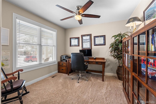 carpeted office space with visible vents, ceiling fan, and baseboards