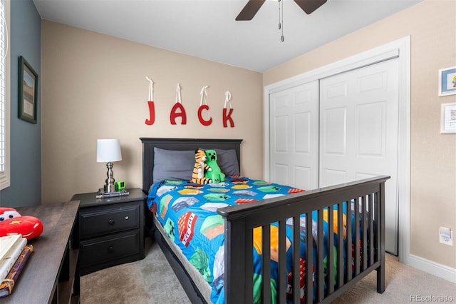 carpeted bedroom with a closet, a ceiling fan, and baseboards