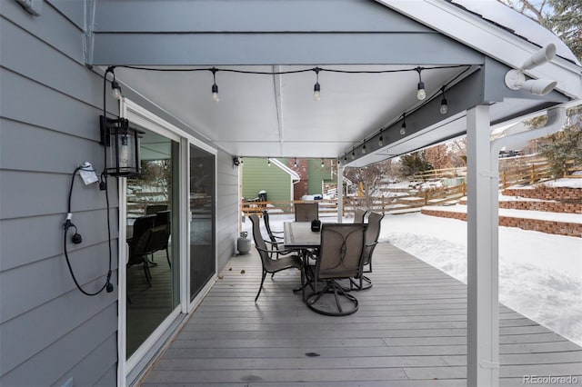 snow covered deck with outdoor dining area