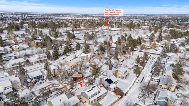 snowy aerial view with a residential view