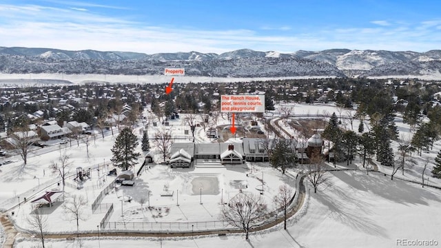 snowy aerial view with a mountain view