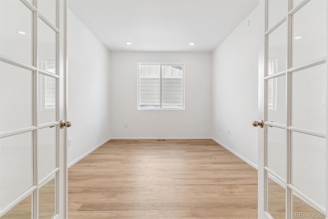 spare room with light hardwood / wood-style floors