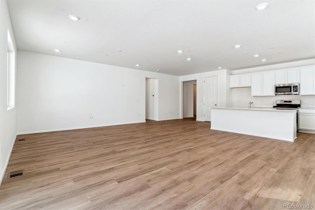 unfurnished living room featuring light hardwood / wood-style flooring