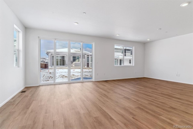 unfurnished room with light hardwood / wood-style floors