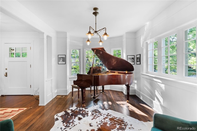 interior space featuring dark wood-type flooring and an inviting chandelier