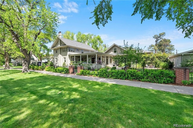 view of front of home with a front lawn and a chimney