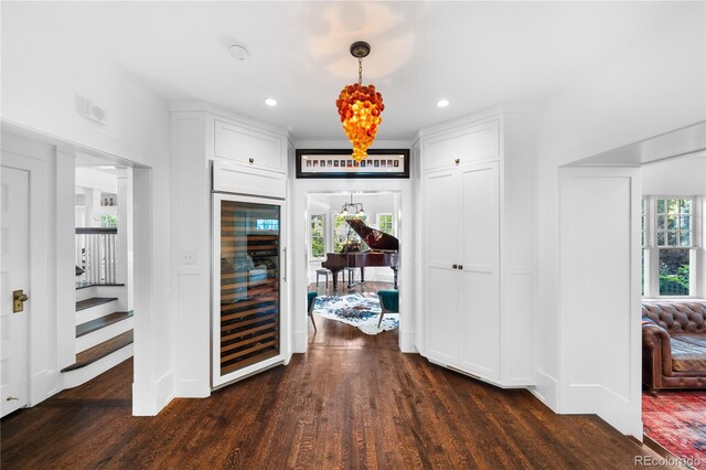 hallway featuring wine cooler, dark wood-style flooring, and recessed lighting