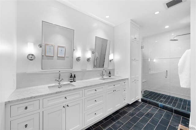 full bathroom featuring double vanity, a sink, visible vents, and a shower stall