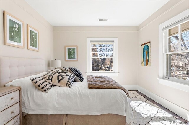 bedroom with baseboards and visible vents