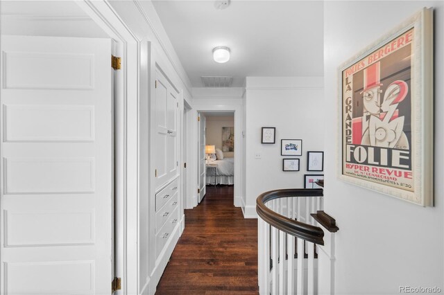 hall featuring visible vents, dark wood finished floors, and baseboards