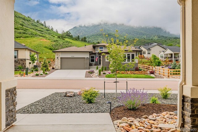 4465 Mesa Top Dr, Monument, CO 80132 - view of front of property with a mountain view, a residential view, concrete driveway, and an attached garage