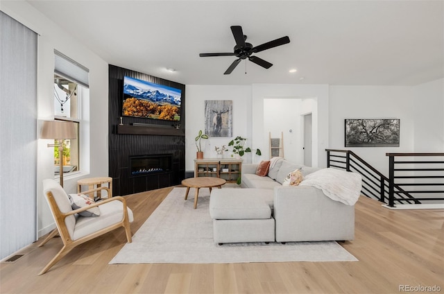 4465 Mesa Top Dr, Monument, CO 80132 - living area featuring wood finished floors, a large fireplace, a ceiling fan, and recessed lighting