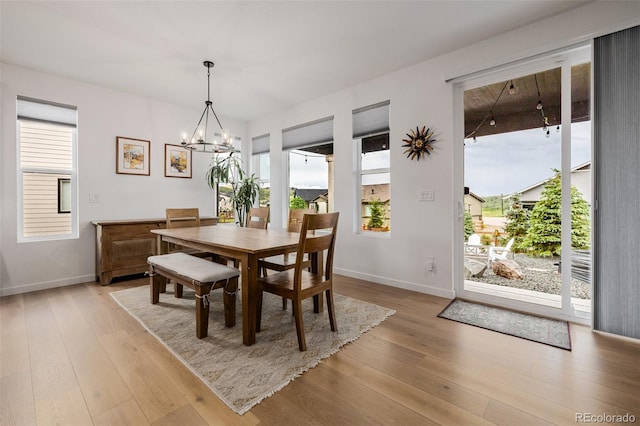 4465 Mesa Top Dr, Monument, CO 80132 - dining space with light wood-type flooring, healthy amount of natural light, and a chandelier