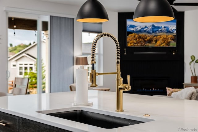 4465 Mesa Top Dr, Monument, CO 80132 - kitchen view of a sink and a warm lit fireplace
