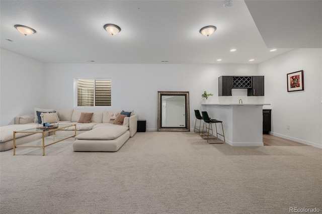 4465 Mesa Top Dr, Monument, CO 80132 - living room featuring bar with sink, recessed lighting, and light colored carpet